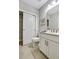 Well-lit bathroom with white cabinets, neutral tile floors, and modern fixtures at 578 Brashy Street, Woodstock, GA 30188