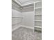 Spacious walk-in closet with built-in shelving and rod for storage at 578 Brashy Street, Woodstock, GA 30188