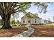 Charming clubhouse entrance with a stone walkway, nestled under a mature shade tree at 578 Brashy Street, Woodstock, GA 30188