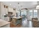 A modern, eat-in kitchen featuring stainless steel appliances and stylish pendant lighting, adjacent to a breakfast nook at 578 Brashy Street, Woodstock, GA 30188