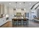A well-lit kitchen boasts an eat-in island with seating, stainless appliances, and ample cabinet space at 578 Brashy Street, Woodstock, GA 30188