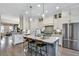 Bright kitchen with a large island, stainless appliances, and hardwood floors, open to the living area at 578 Brashy Street, Woodstock, GA 30188