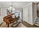 Elegant living area with a grand piano and hardwood floors; a perfect blend of sophistication and comfort for modern living at 578 Brashy Street, Woodstock, GA 30188