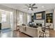Bright living room with a cozy fireplace, hardwood floors, and stylish furniture offering a comfortable and inviting space at 578 Brashy Street, Woodstock, GA 30188