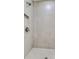 Modern shower featuring sleek tilework, a shower head, and a built-in shelf at 578 Brashy Street, Woodstock, GA 30188