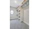 Spacious walk-in closet with ample shelving and a charming round window at 578 Brashy Street, Woodstock, GA 30188