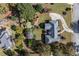 Aerial view showcases backyard, mature trees, landscaping, and a deck at 1453 Reagan Cir, Conyers, GA 30012
