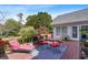 A serene wooden deck with a seating area and views of the lush, landscaped backyard at 1453 Reagan Cir, Conyers, GA 30012