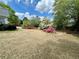 Well-maintained backyard featuring flowering azaleas, mature trees, and ample green space at 1453 Reagan Cir, Conyers, GA 30012