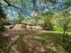 Lush backyard featuring mature trees, vibrant landscaping, and a view of the charming home at 1453 Reagan Cir, Conyers, GA 30012