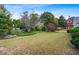 A expansive grassy backyard with mature trees and lush landscaping at 1453 Reagan Cir, Conyers, GA 30012
