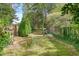 A verdant backyard with trees and a wooden fence at 1453 Reagan Cir, Conyers, GA 30012