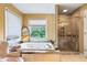 Elegant bathroom featuring a large jetted tub, separate shower, and serene views from the window at 1453 Reagan Cir, Conyers, GA 30012
