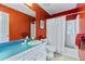Bathroom with vibrant red walls, a blue countertop, and a shower-tub combination at 1453 Reagan Cir, Conyers, GA 30012