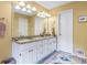 Bright bathroom with double vanity, granite countertop, ample cabinet space, and decorative rug at 1453 Reagan Cir, Conyers, GA 30012