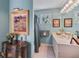 Bathroom with teal colored walls, stained glass window, and white cabinetry at 1453 Reagan Cir, Conyers, GA 30012