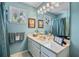 Bathroom with teal colored walls, stained glass window, and white cabinetry at 1453 Reagan Cir, Conyers, GA 30012