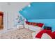 A cozy bedroom featuring a blue accent wall and a comfortable white sofa with red pillows at 1453 Reagan Cir, Conyers, GA 30012