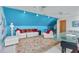 Spacious bonus room with a colorful accent wall, comfortable seating, and stylish decor at 1453 Reagan Cir, Conyers, GA 30012