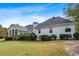 Spacious home exterior featuring a back deck, well-maintained lawn, and mature landscaping at 1453 Reagan Cir, Conyers, GA 30012