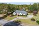 Aerial view of the home displaying its well-manicured lawn, circular driveway, and mature landscaping at 1453 Reagan Cir, Conyers, GA 30012