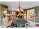 Bright eat-in kitchen with wooden cabinets and stainless steel appliances open to the dining and living rooms at 1453 Reagan Cir, Conyers, GA 30012