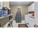 Laundry room featuring tile flooring, white washer and dryer and storage cabinets at 1453 Reagan Cir, Conyers, GA 30012
