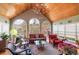 Bright sunroom with wood ceiling, large windows offering natural light, and comfortable seating at 1453 Reagan Cir, Conyers, GA 30012