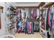 Organized walk-in closet featuring ample hanging space, shoe racks, and built-in shelving at 1453 Reagan Cir, Conyers, GA 30012