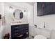 Stylish powder room with a navy vanity, marble countertop, and unique decorative elements at 2080 Silversmith Ln, Stone Mountain, GA 30087