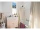 Bright bathroom featuring a pedestal sink with vintage-style fixtures and a shower with striped curtains at 3 Park Ne Ln # H, Atlanta, GA 30309