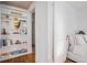 Bright bedroom showing built-in bookshelves and a glimpse of a bed with white linens at 3 Park Ne Ln # H, Atlanta, GA 30309