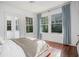 Sun-filled bedroom with hardwood floors, large windows, and neutral decor at 3 Park Ne Ln # H, Atlanta, GA 30309
