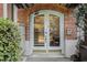 Inviting building entrance with decorative glass doors and brick archway, exuding elegance at 3 Park Ne Ln # H, Atlanta, GA 30309