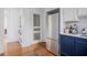 Kitchen featuring stainless steel refrigerator, blue cabinets and view into another room at 3 Park Ne Ln # H, Atlanta, GA 30309
