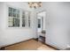 Bright sitting area with large windows and hardwood floors offering a view into another bedroom at 3 Park Ne Ln # H, Atlanta, GA 30309