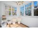 Cozy sitting area with large windows, hardwood floors, and stylish lighting at 3 Park Ne Ln # H, Atlanta, GA 30309