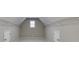 Unfinished attic space with overhead storage shelving and window at 3835 Greenside Ct, Dacula, GA 30019