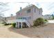 Spacious backyard featuring a brick home with an upper-level deck and patio area at 3835 Greenside Ct, Dacula, GA 30019