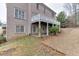 Brick home's backyard features a well-maintained lawn, a small patio, and an upper-level deck at 3835 Greenside Ct, Dacula, GA 30019