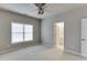 Neutral bedroom with a ceiling fan, large window, and carpeted floors, creating a cozy and inviting space at 3835 Greenside Ct, Dacula, GA 30019