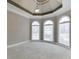 Bedroom with trey ceilings, decorative trim, arched windows, and neutral carpet at 3835 Greenside Ct, Dacula, GA 30019