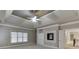 Bedroom featuring plush carpeting, a tray ceiling, built-in shelving, and a fireplace at 3835 Greenside Ct, Dacula, GA 30019