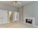 Bedroom with neutral carpet, a fireplace, and doorways leading to other rooms and closets at 3835 Greenside Ct, Dacula, GA 30019