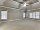 Spacious primary bedroom with tray ceiling, fan, and large windows with blinds at 3835 Greenside Ct, Dacula, GA 30019