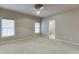 Spacious bedroom with two windows offering natural light and a ceiling fan at 3835 Greenside Ct, Dacula, GA 30019