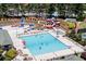A large community pool with water slides, lounge chairs, and umbrellas, providing a perfect summer getaway for residents and families at 3835 Greenside Ct, Dacula, GA 30019