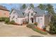 Well-manicured brick home boasting a lush lawn, mature landscaping, and an elegant arched entryway at 3835 Greenside Ct, Dacula, GA 30019