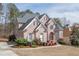 Beautiful brick home featuring an arched entry, well-kept lawn, and professional landscaping at 3835 Greenside Ct, Dacula, GA 30019