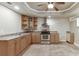 Open kitchen with stainless steel appliances, cabinets, and tile floor at 3835 Greenside Ct, Dacula, GA 30019